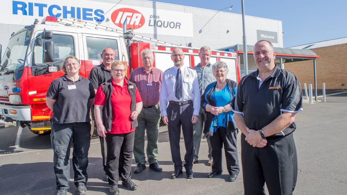Helping hand: Cobden IGA staff, community members and charity representatives celebrate a combined $40,000 donation between the Ritchies Cobden store and the wider IGA network to the fire relief effort. Picture: Christine Ansorge
