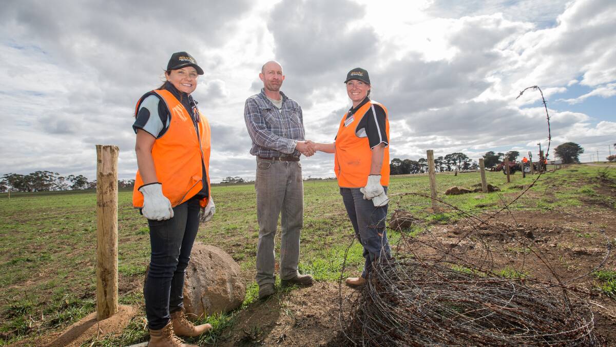 Thanks: Elingamite farmer Tim Howard thanks Blaze Aid volunteers Sarah Butler, left, and Melissa Jones for the work and vouchers for fencing materials that Blaze Aid has given him to replace burnt fencing. Picture: Christine Ansorge