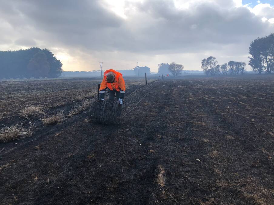 Burnt Out: Blaze Aid volunteers help to clear burnt fences from an Elingamite farm, after the St Patrick's Day fires. Picture: Rob Gunstone