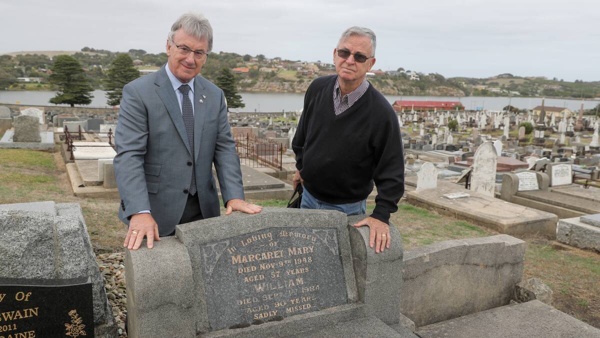 Warrnambool mayor Robert Anderson looks at the grave of his grandfather, William Anderson, with Warrnambool RSL's Doug Heazlewood ahead of Anzac Day cemetery tours. Picture: Rob Gunstone
