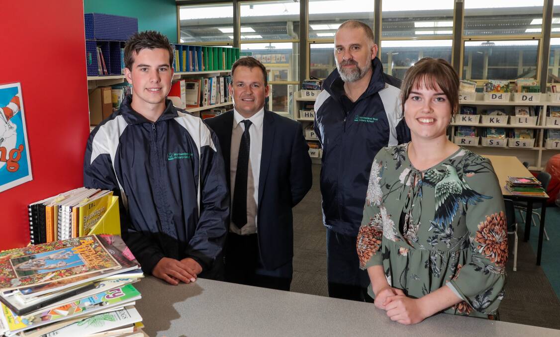 Employed: Trainees Josh Hrabar, left, and Shelby Jenkins, right, with Wayne Robertson and Phil Barnes at Warrnambool West Primary School. Picture: Morgan Hancock