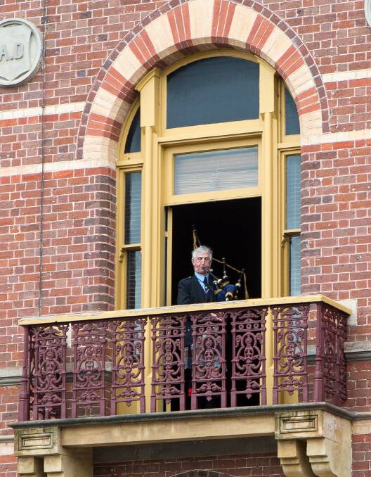 Stirring: A bagpipe player plays from a balcony at the Corangamite Civic Centre during the festival. 