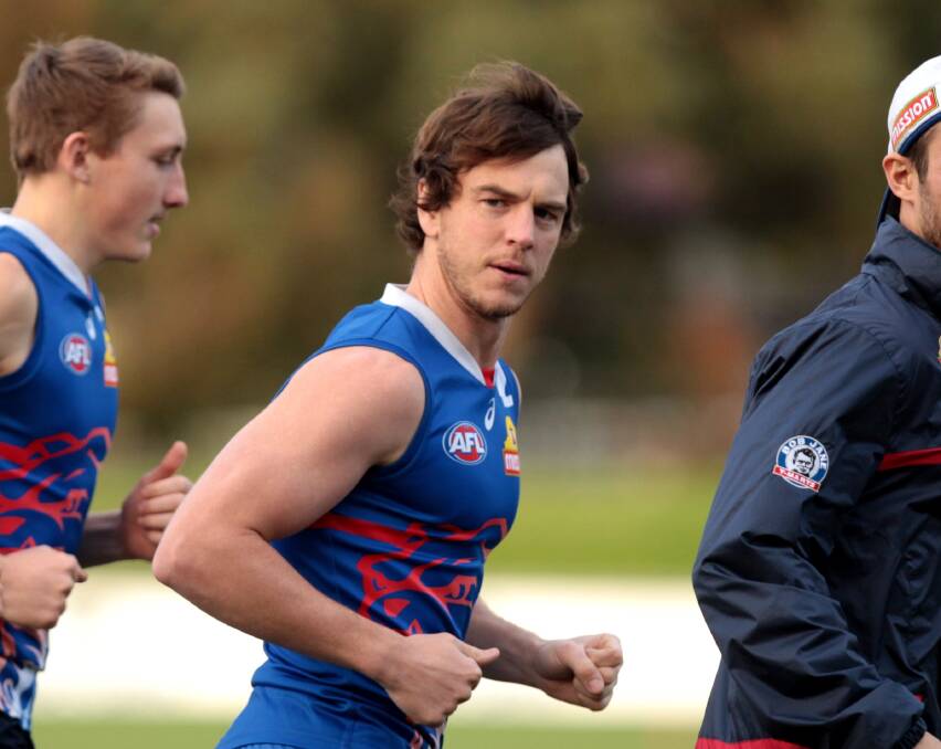 BACK AT IT: Western Bulldogs player Liam Picken (centre) warms up with teammates during his return to team training on Tuesday. Picture: Stefan Postles/AAP