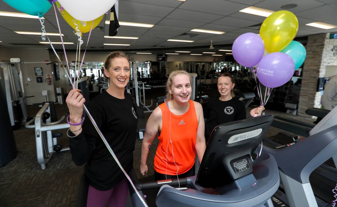 WALK ON: Anytime Fitness gym manager Jade Thwaites (left) and personal trainer Jaymee-Lea Hope (right) help club member Alex Marsh through her session in the Tread Together Challenge. Picture: Rob Gunstone