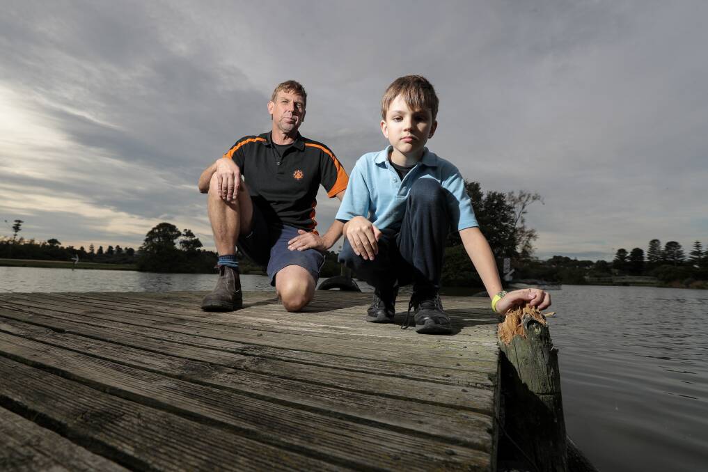 Unhappy: Lake Pertobe motor boat hire operator John Stephens and his son Ronan, 9, are angry vandals broke most posts off a boat jetty used to access the popular boats. Picture: Rob Gunstone