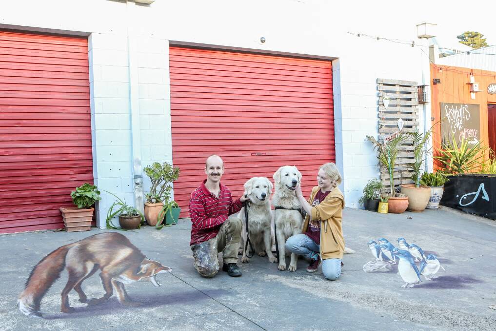 Warrnambool artists Jimmy Buscombe and Alara Harris with maremma's Amor and Avis at the 3D artwork on Little Liebig Lane. Picture: Christine Ansorge