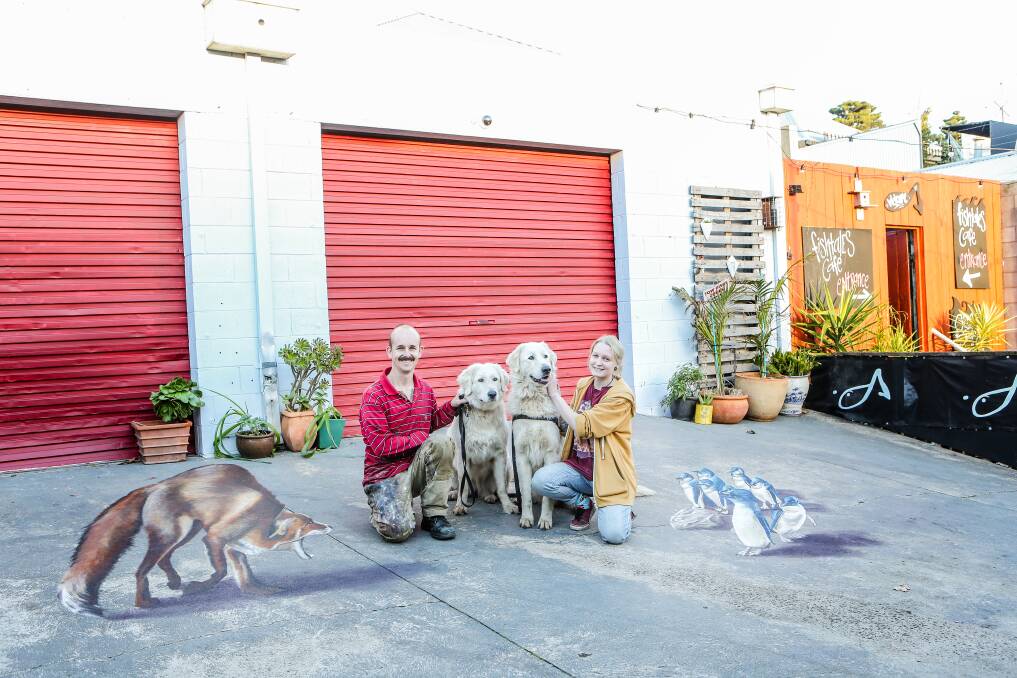 Illusion: Jimmy Buscombe and Alara Harris with maremmas Amor and Avis at the 3D artwork on Little Liebig Lane. Picture: Christine Ansorge