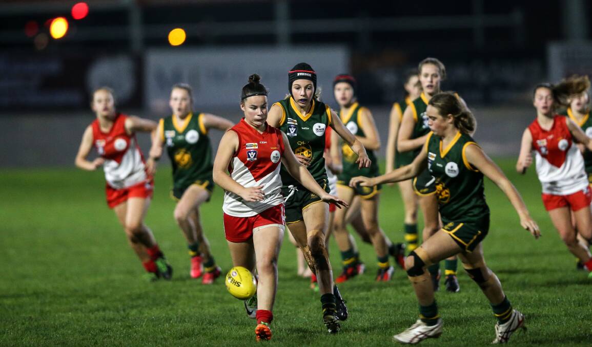 BRIGHT LIGHTS: South Warrnambool and Old Collegians play a night match during the 2018 DUFFL season. Picture: Christine Ansorge