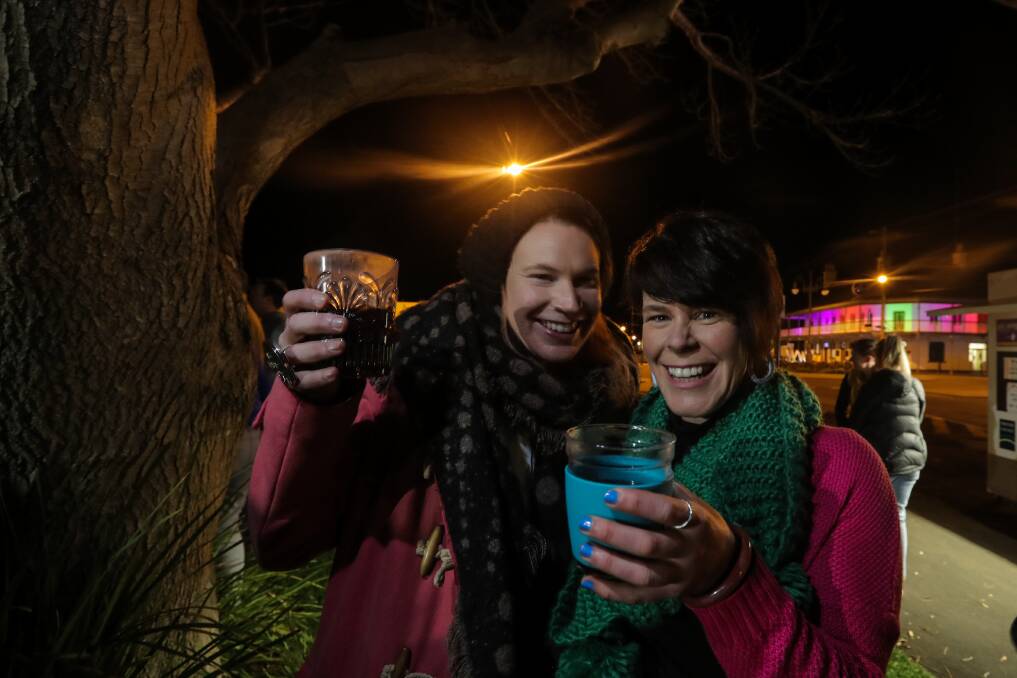 Cheers: Port Fairy's Holly and Amanda Sheehan were rugged up and enjoying a glass of mulled wine on the Fiddler's Green at the start of the 2018 Winter Weekends program. Pictures: Rob Gunstone