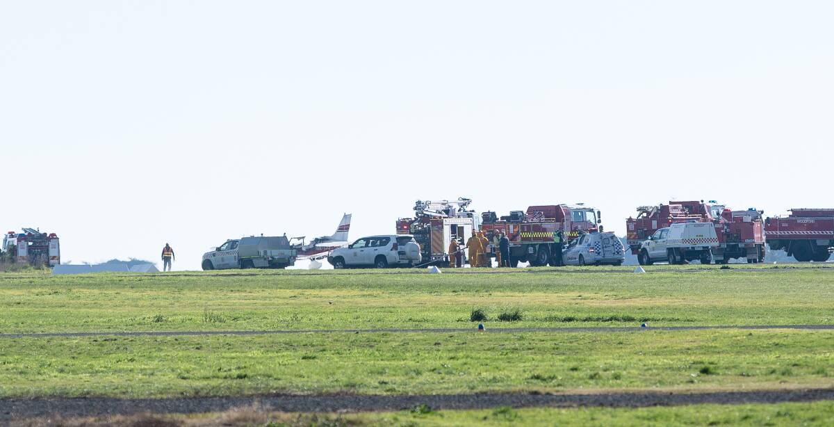 Big response: Emergency vehicles gather around the burnt plane, far left, on a runway at Warrnambool Airport. 