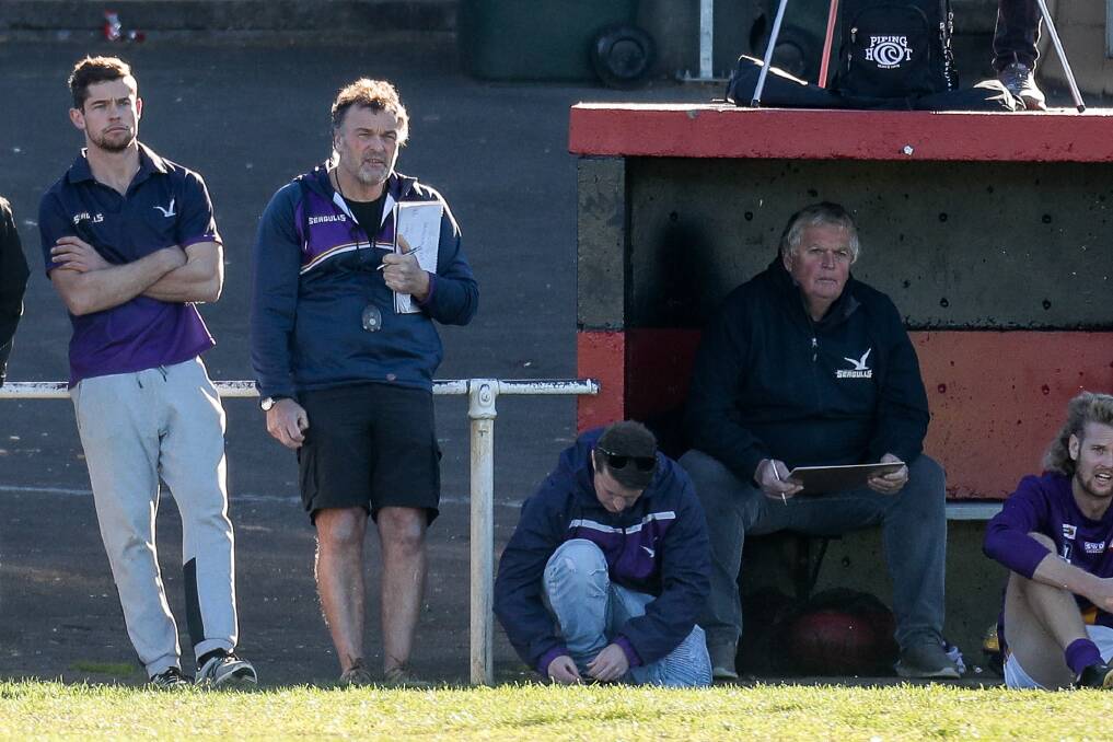 SIDELINED: Port Fairy coach Dan Nicholson (left) stands on the Seagulls' bench. He missed the match against Warrnambool with general soreness. Picture: Morgan Hancock