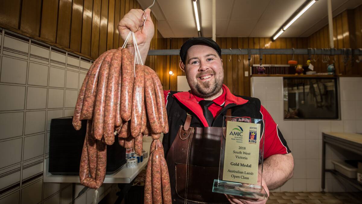 Delicious: 'A Cut Above' Terang butcher Kieran Dart with his award-winning 'Lamb Honey and Rosemary' sausages. Picture: Christine Ansorge