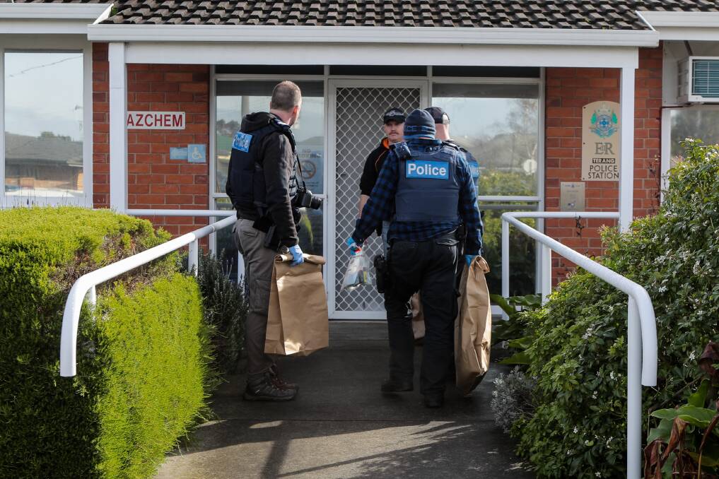 Terang and Warrnambool police officers carry evidence bags into the Terang station after a series of raids on Thursday. Picture: Rob Gunstone