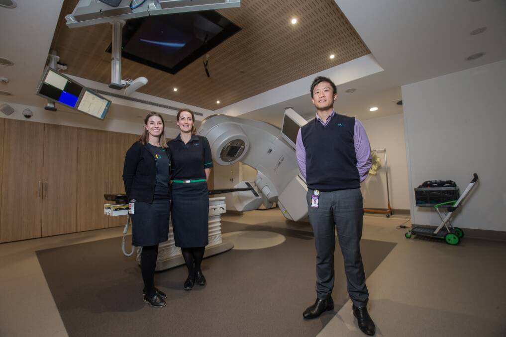 Technology: South West Regional Cancer Centre Icon Group charge radiation therapist Louis Huynh (front) and radiation therapists Lauren Clothier and Loretta Marr with the True Beam Linear Accelerator. Picture: Christine Ansorge