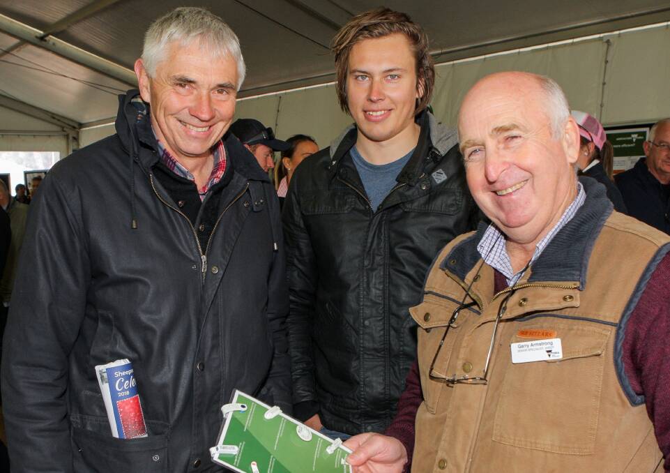 Poll Merino breeders Alan and Hamish Wishart of Inverleigh talk with Agriculture Victoria's Garry Armstrong about the sheep electronic identification (EID) program. Picture: Everard Himmelreich