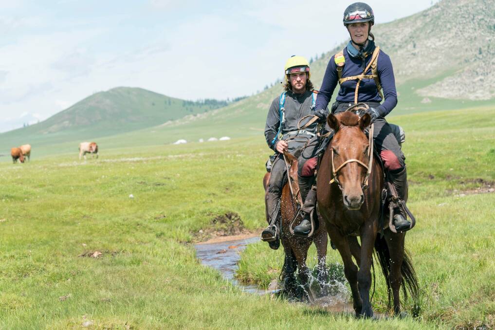 Annabel Neasham (front) with Australian Adrian Corboy in Mongolia. Picture: Laurence Squire and The Adventurists Longest Horse Race in Mongolia