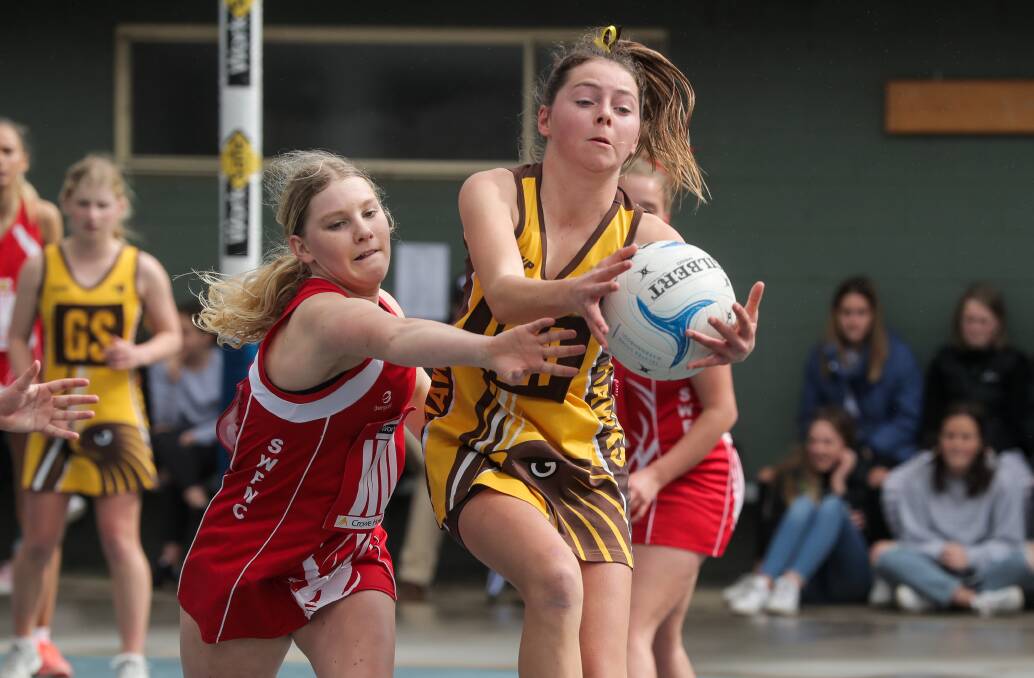 CHARGE: South Warrnambool's Annelli Cook and Hawk's Molly O'Brien in action during the Hampden juniors under 16 netball grand final last season. Picture: Rob Gunstone