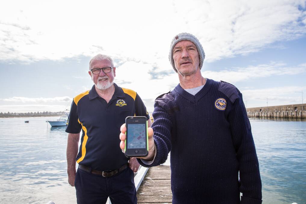 HEROES: Warrnambool Coast Guard commander Allan Wood and skipper David Francis with the GoodSAM app which alerts first aid trained bystanders to people suffering from cardiac arrest. Picture: Christine Ansorge