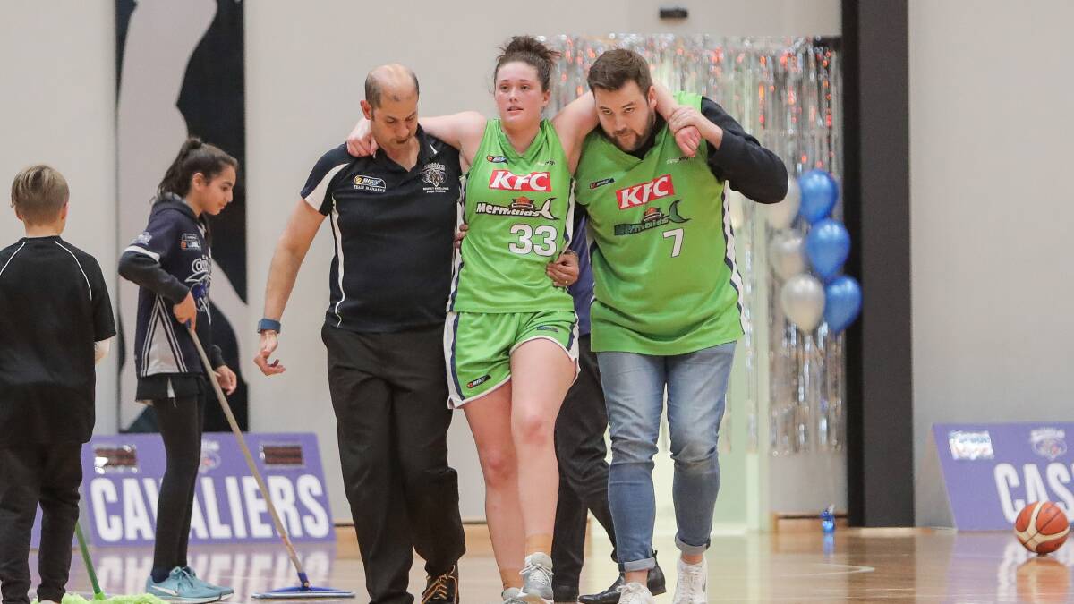 SOUR: Molly McKinnon of the Warrnambool Mermaids is carried off court with a knee injury. Picture: Morgan Hancock 