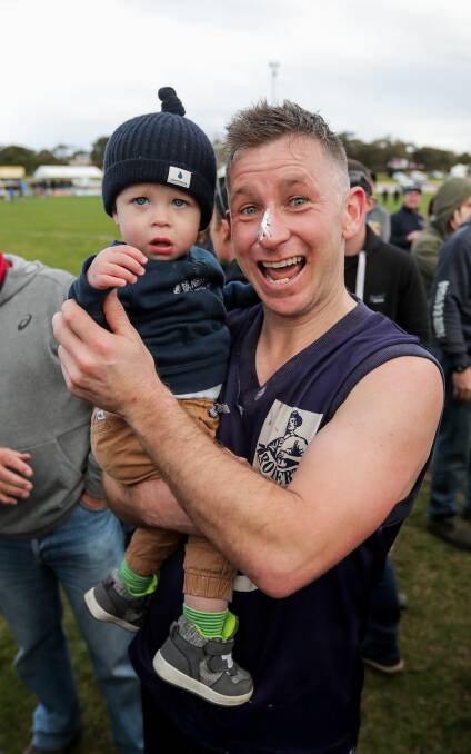 GO DAD: Aaron Searle celebrates the victory with his son Carter.