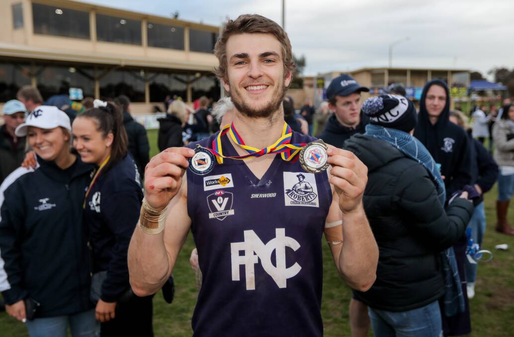 ONE OF THE BEST: John Paulin shows off his Scotty Stewart Medal for best on ground and his premiership medallion. Picture: Morgan Hancock 