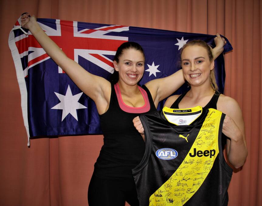 AUSSIE PRIDE: EKB fitness and Aerobics athletes Emily Daniels and Sophie Bellman show off what they have on offer in their silent auction. Picture: Sean Hardeman 