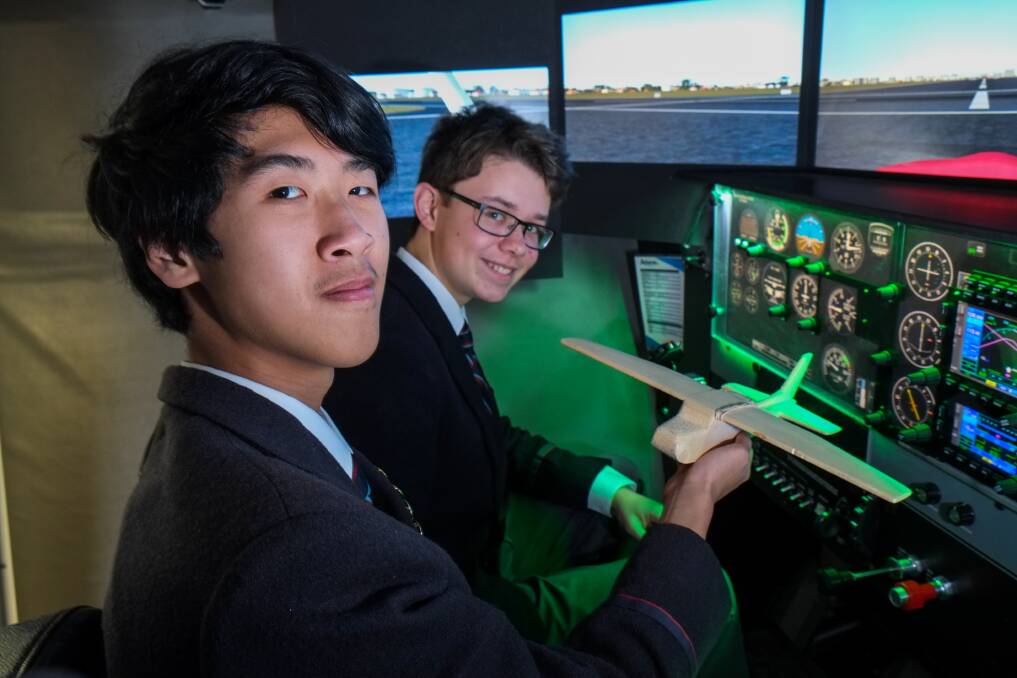 Taking flight: Emmanuel College year 9 students Anh Dang, 15, and Dominic McElgunn, 15, take the controls of a flight simulator. Picture: Rob Gunstone