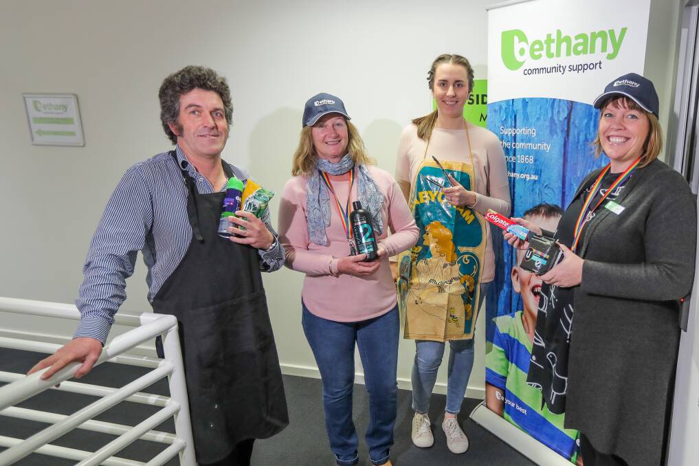 Here to help: Bethany Community Support's David Lodge, Claire Browne, Lisa Ryan and Kristie Low show off some of the items that Bethany are ready to cook up a storm at their fund-raising barbecue on Friday for their toiletry donation drive. Picture: Morgan Hancock