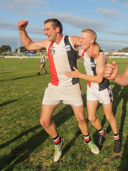 BROTHERS IN ARMS: Koroit siblings Todd McLean and Alex Pulling enjoy the Saints' grand final win moments after the siren on Saturday. Picture: Morgan Hancock