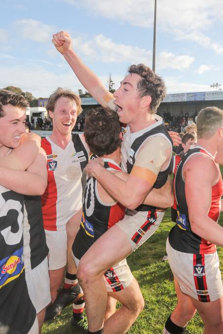 WE'RE NUMBER ONE: Koroit's Taylor Mulraney is lifted up during the Saints' grand final celebrations at Reid Oval. Picture: Morgan Hancock
