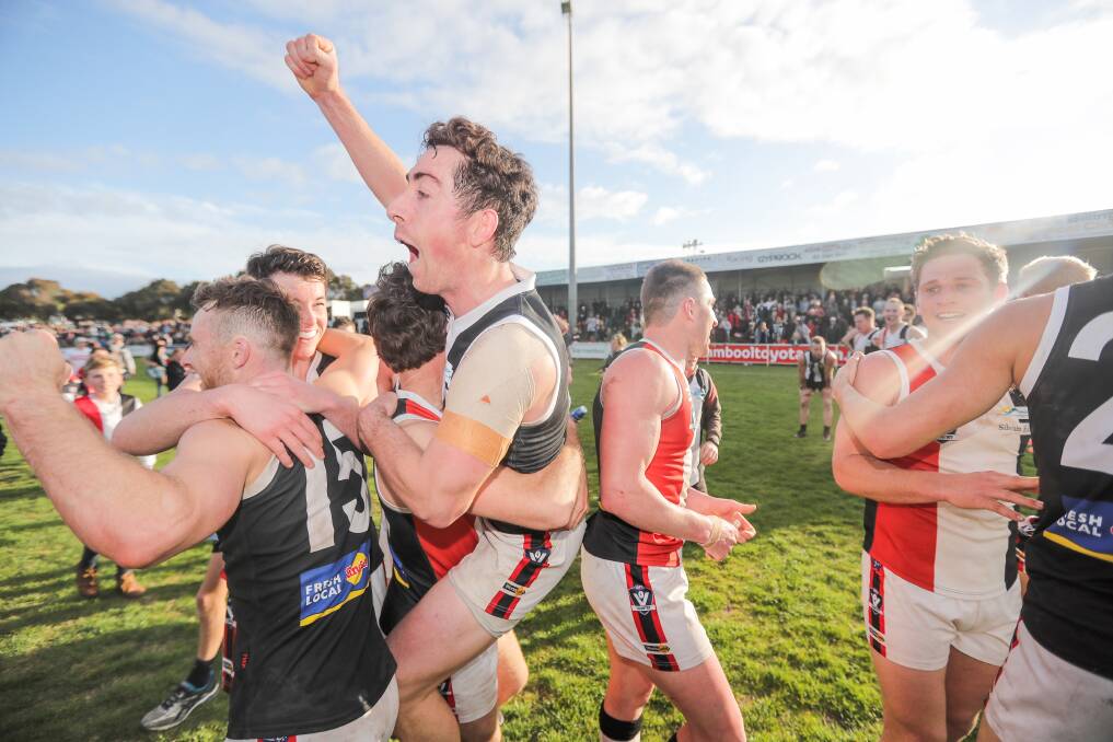 JUMPING FOR JOY: Koroit's Taylor Mulraney is lifted up during the Saints' premiership celebrations. Picture: Morgan Hancock