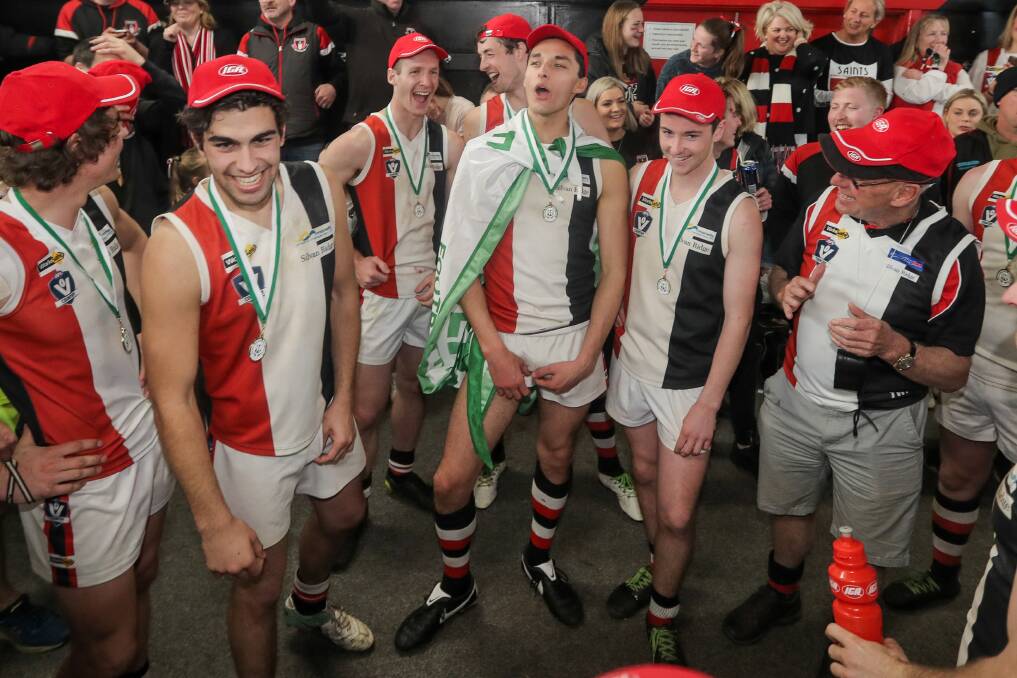 THE TEAM WE LOVE SO DEAR: Koroit players sing the song after winning their fifth consecutive premiership. Picture: Morgan Hancock
