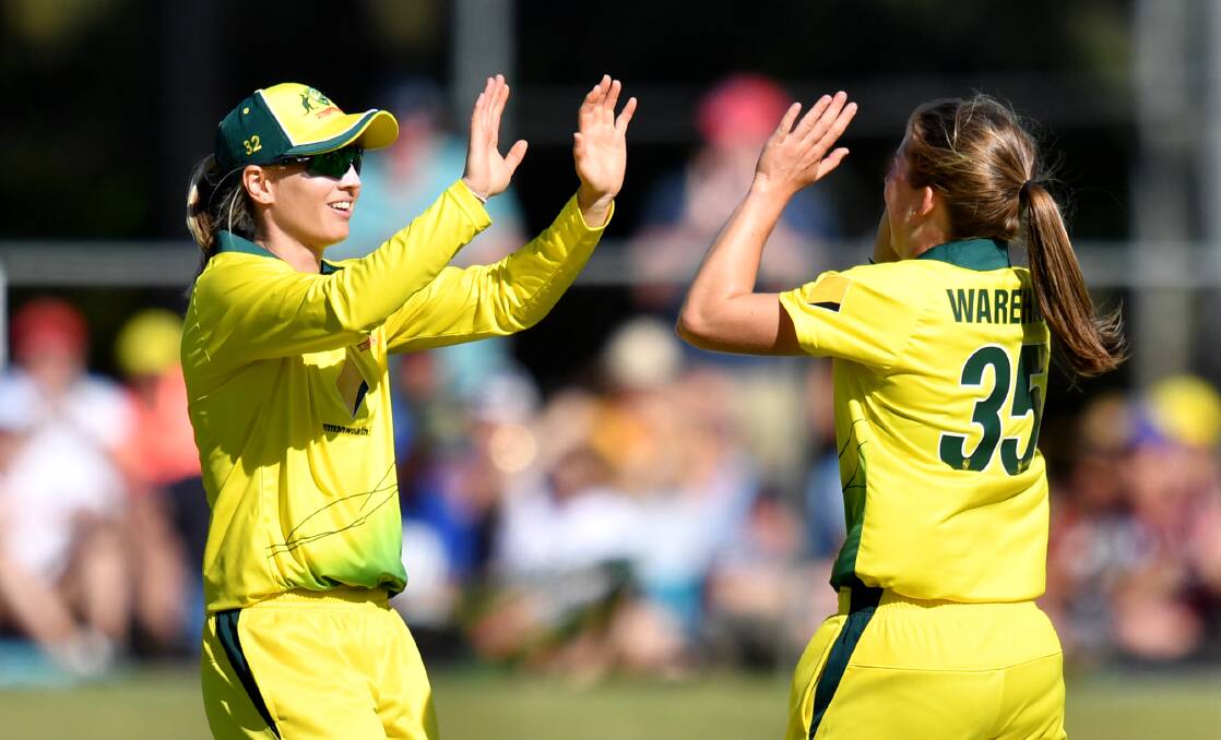 TOP STAGE: Georgia Wareham gets the high five after she took her second international wicket against New Zealand. Picture: Darren England/AAP Image