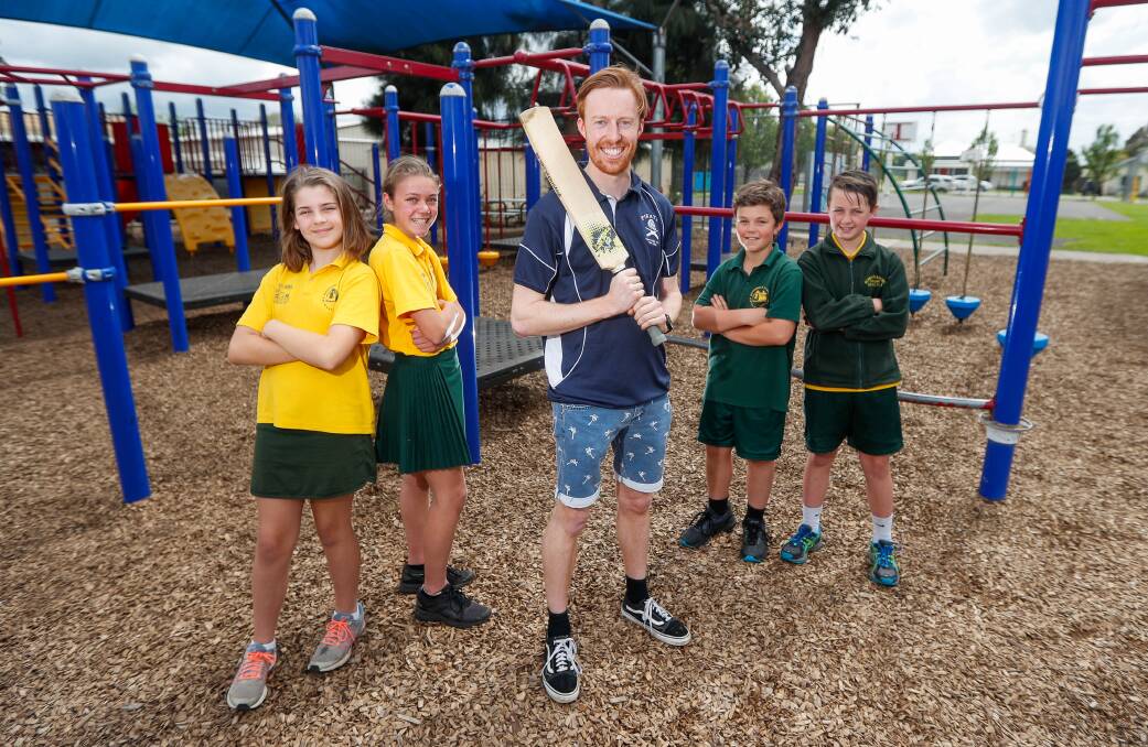 RIVALS: Port Fairy cricketer Niahl Dwyer surrounded by Allansford and District Primary School students Teegan Wickham, Georgia Rea, Hugo Artz and Morgan Cook. Picture: Morgan Hancock