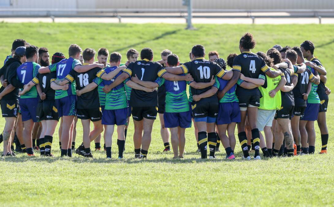 AS ONE: Warrnambool Raiders and Gunditjmara Bulls players arm in arm after the first derby on Saturday. Picture: Michael Chambers