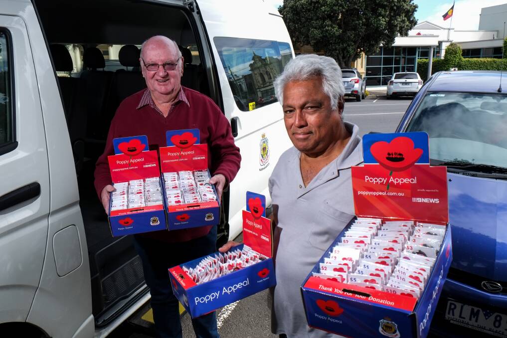 Remembering: Warrnambool RSL president John Miles and appeals coordinator Llewellyn Matthews distribute boxes of poppies around the city. Picture: Rob Gunstone