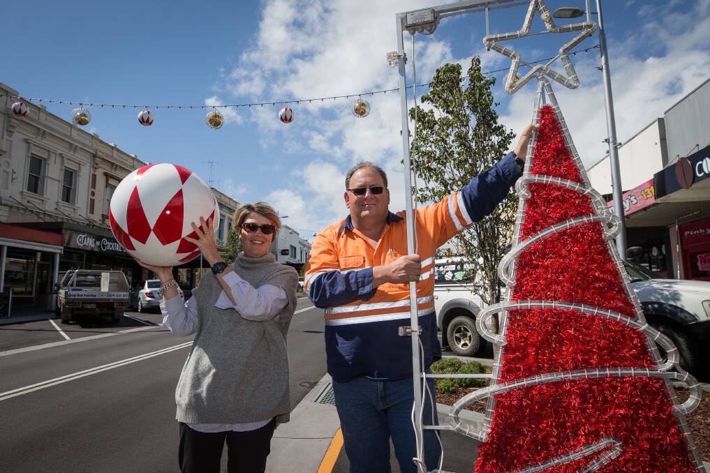 TIS THE SEASON: Warrnambool City Council events and promotions coordinator Bec Elmes and electrician Darrell Hose are excited about the newly installed Christmas decorations in Liebig Street. Picture: Christine Ansorge