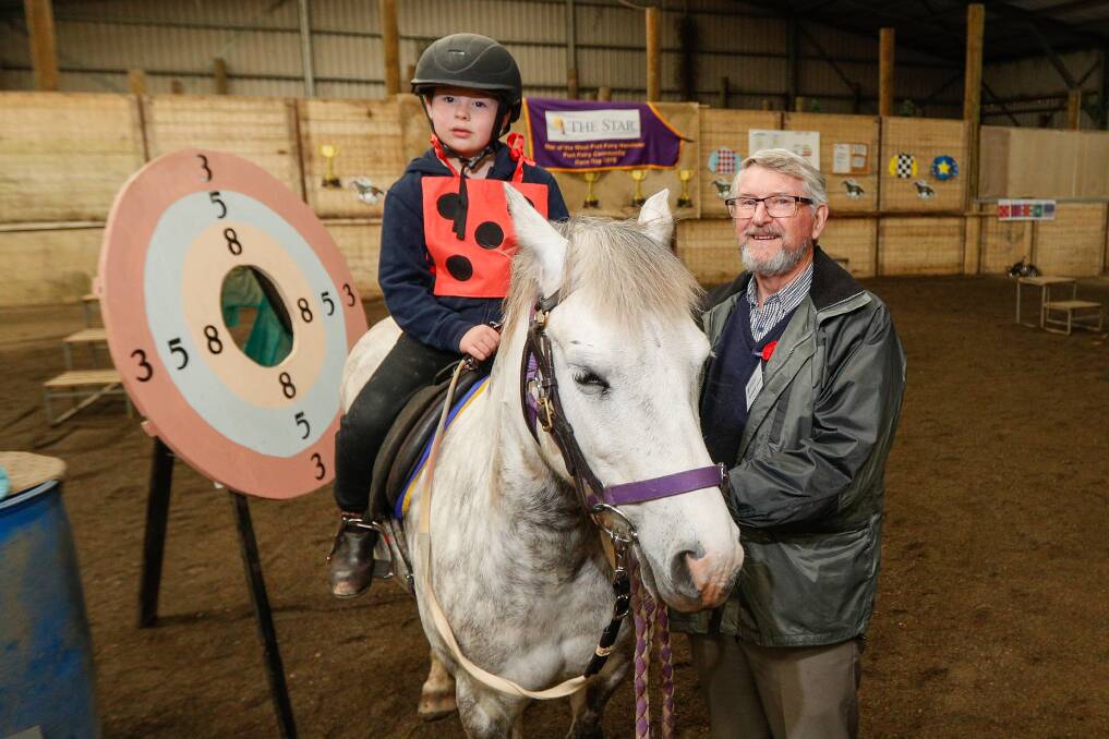 New mount: Coen Rigg Fawkes enjoys a ride on Daphne, with Barrie Baker, South West Community Foundation chair. Picture: Morgan Hancock