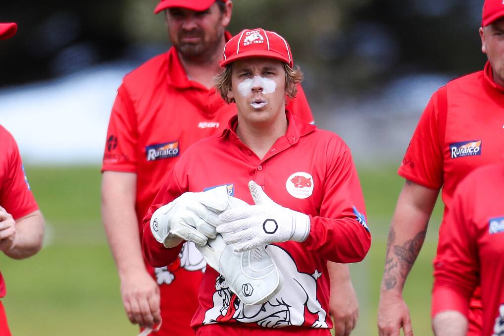 Job done: Dennington's Stui Brown leaves the field after the Dogs bowled Port Fairy out for just 83 runs.  Picture: Morgan Hancock