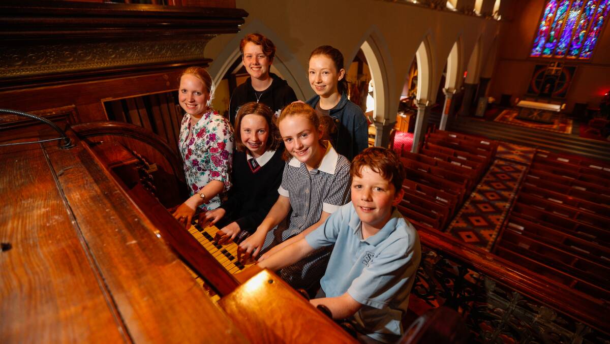 Pipe organists: Teacher Sonia Beal, Alyssa Miles O'Bray, 13, Ellie Holden, 11, James Hovey, 11, (back) Emily Hovey, 14, and Ana Barker, 15 huddle around the organ at St. Joseph's in Warrnambool. Picture: Morgan Hancock