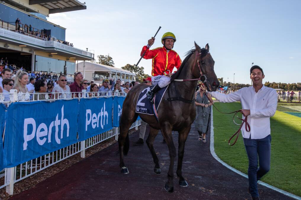 Job done: Jockey Damien Oliver celebrates after riding Voodoo Lad to victory in the Crown Perth Winterbottom Stakes at Ascot Racecourse. Picture: AAP Image/Richard Wainwright.