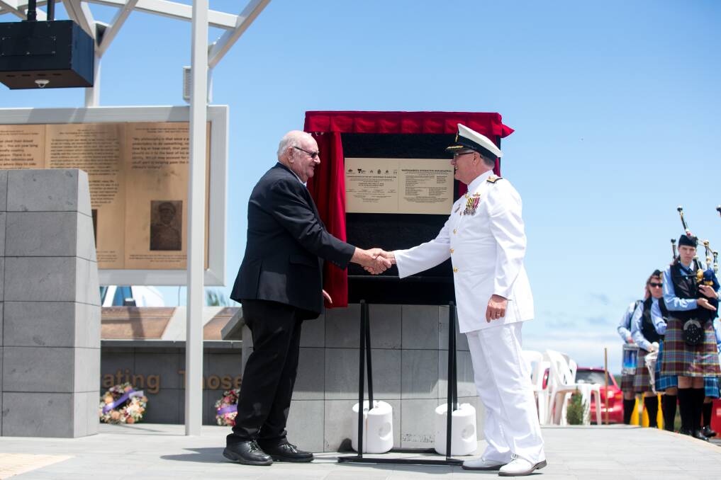 Warrnambool RSL president John Miles and Commodore Greg Yorke CSC RANR unveil the plaque to officially open the new Warrnambool war memorial.