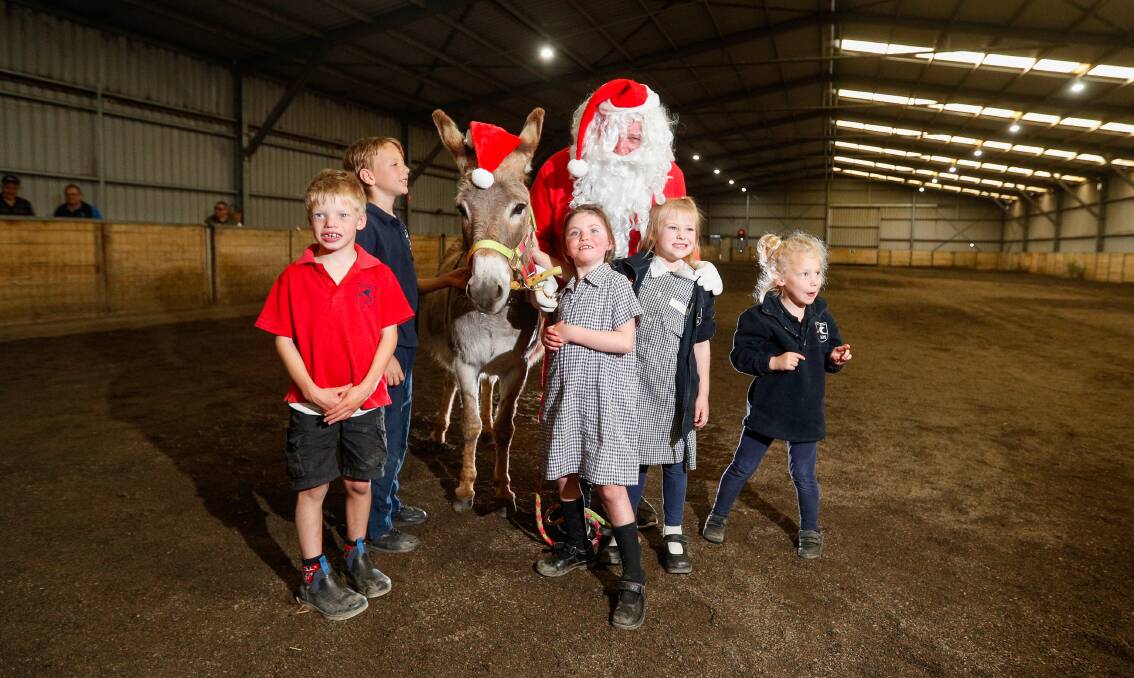 Ho ho ho: RDA students Luke Graesser, Devin, Claire McNeil, Emma Whittington and Hannah Ind were thrilled to pose with Santa and Reuben the donkey at the end of year Christmas party. Picture: Morgan Hancock