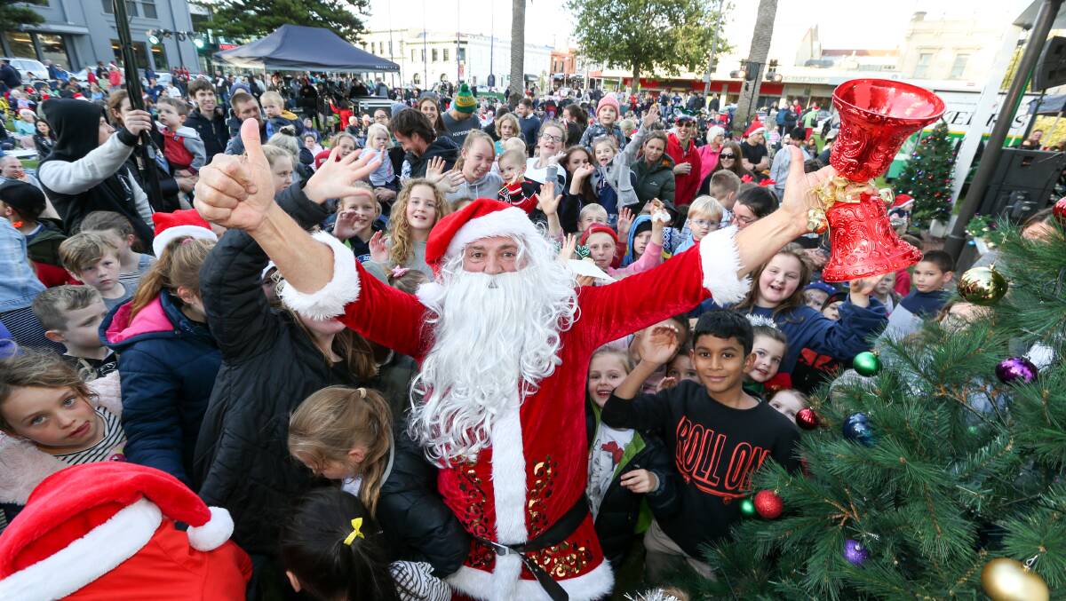SPREADING CHEER: Santa puts smiles on the faces of children at Carols on the Green in 2018. 