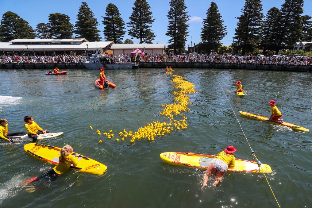 Finish line: A huge crowd watches at the Duck Derby comes close to a finish at the favorite New Year's Day event. Picture: Rob Gunstone