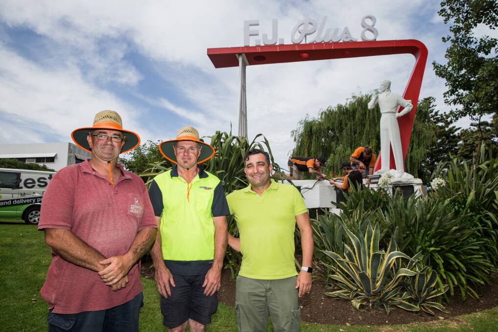 Happy day: Site manager Troy Kelly, Montgomery International employee Ken Trigg and Seen Technology's Rob Grosso with newly installed Plus 8 Man in the Fletcher Jones gardens. Picture: Christine Ansorge