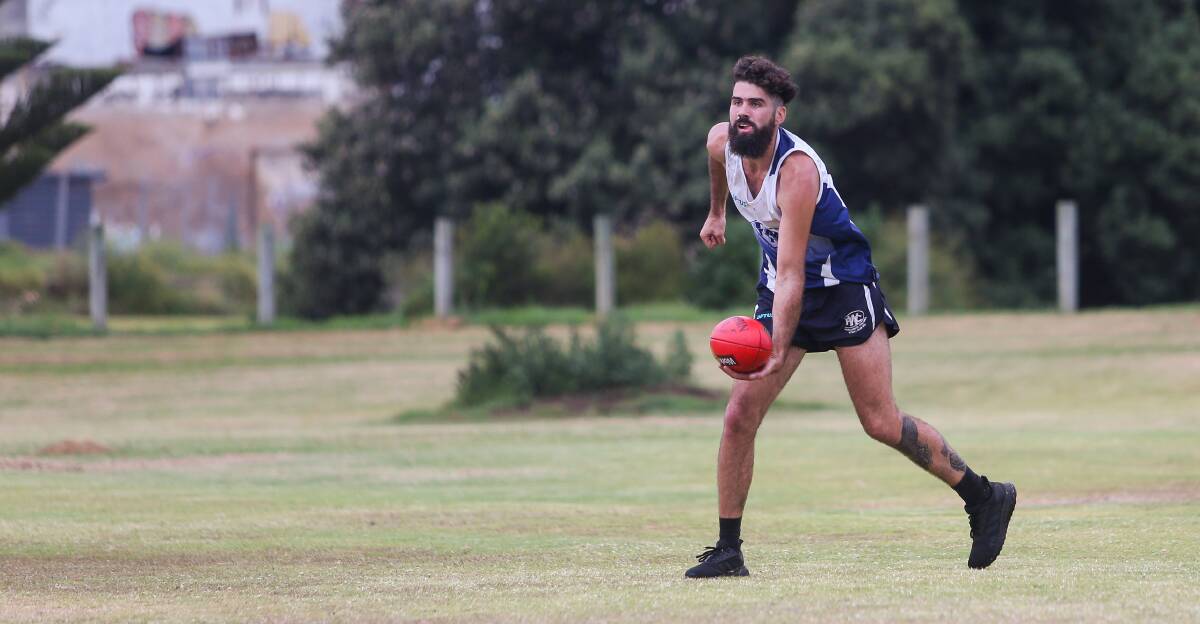 WORKING HARD: Warrnambool recruit Alex Shipard prepares to dish off a handpass during a Blues' pre-season training session on Friday at Jetty Flat. Picture: Morgan Hancock