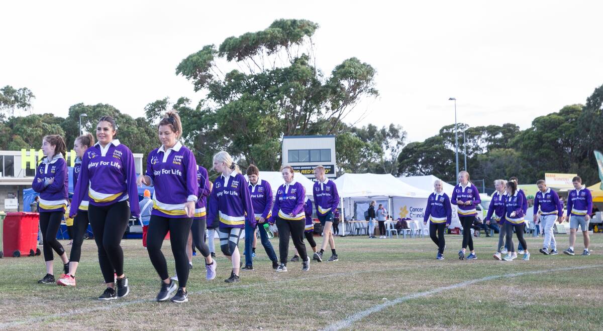 Warrnambool Relay for Life participants walk around the oval at Deakin University Picture: Christine Ansorge