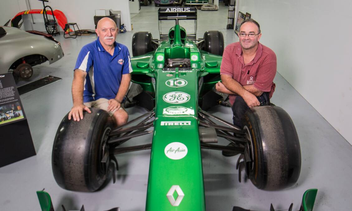 GREEN MACHINE: Mick Kantsaros and Troy Kelly pose with the Formula One car that will be on show on Saturday. Picture: Christine Ansorge