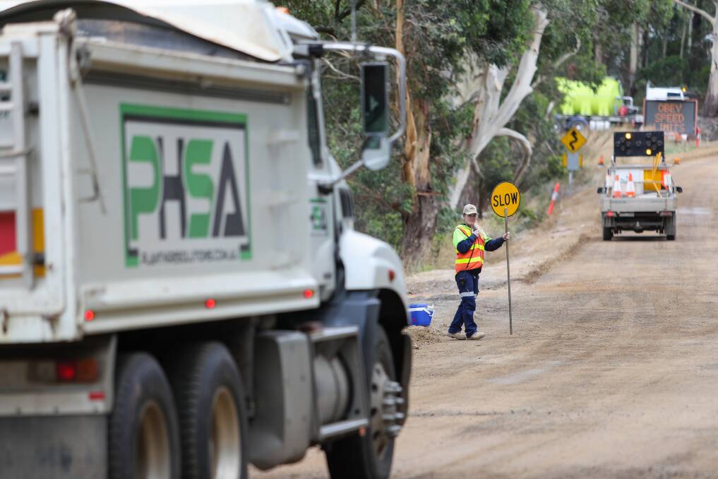 Joss Retallack holding a traffic sign during road works. The south-west has a number of job openings involving traffic jobs. Picture: Morgan Hancock